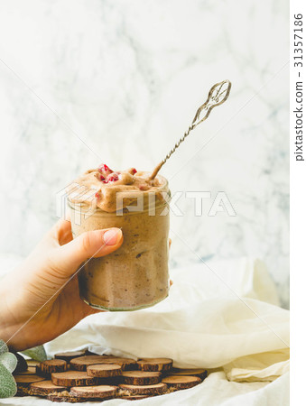 Woman holding in hand jar of chocolate icecream Woman holding in hand jar of chocolate icecream 31357186