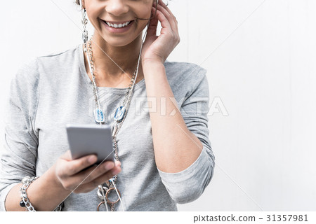 Joyful stylish girl is using mobile outdoors 31357981