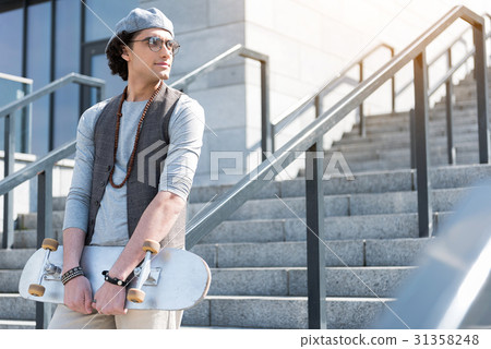 Confident stylish teen is leaning on handrails 31358248