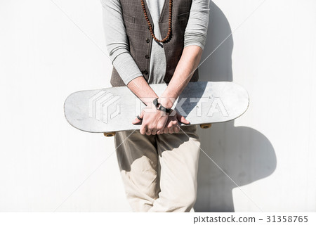 Young stylish guy is standing with board Young stylish guy is standing with board 31358765