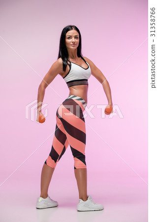The woman training against pink studio 31358766