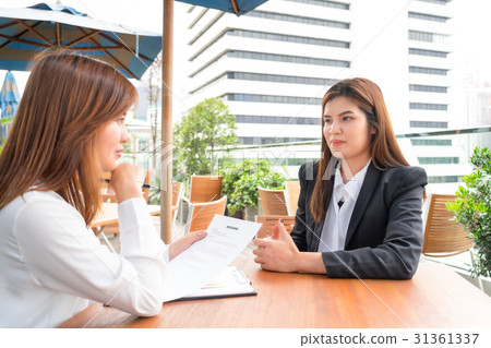 Businesswoman interview her candidate with resume Businesswoman interview her candidate with resume 31361337