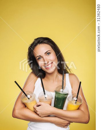 Happy smiling woman holding smoothie 31362480