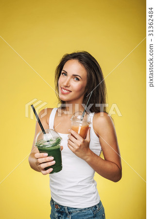 Happy smiling woman holding smoothie 31362484