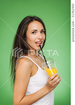 Happy young woman drinking smoothie 31362485