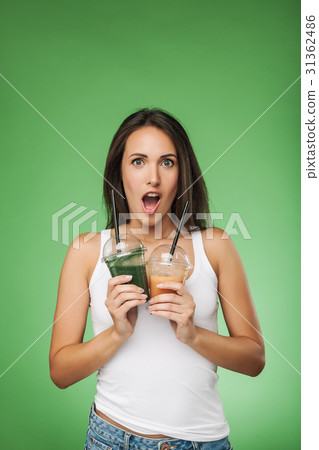 Young surprised woman holding smoothie 31362486
