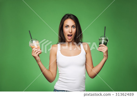 Young surprised woman holding smoothie 31362489