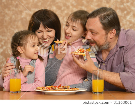 Happy family with children eating pizza 31363061