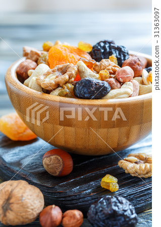 Nuts and dried fruit in a wooden bowl. 31363097