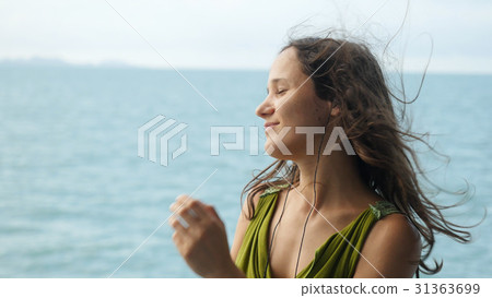Beautiful dreamy young woman listening to music on Beautiful dreamy young woman listening to music on 31363699