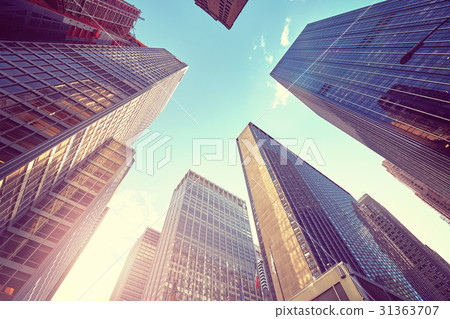 Stylized photo of Manhattan skyscrapers at sunset. 31363707