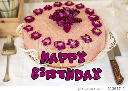Close up cream cake violet flowers on top 31363741
