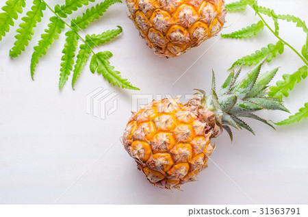 Ripe pineapples on white wooden table background 31363791