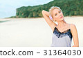 Beautiful white woman with short hair on a beach ( 31364030