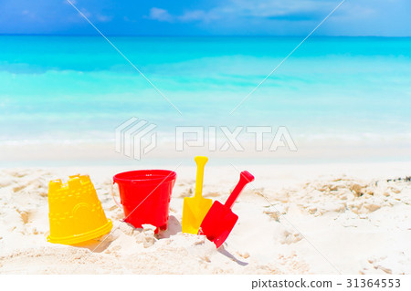 Kid's beach toys on white sandy beach background Kid's beach toys on white sandy beach background 31364553