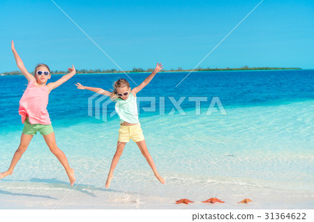 Adorable little girls having fun on the beach full 31364622