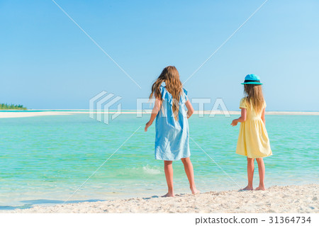 Little girls having fun at tropical beach playing Little girls having fun at tropical beach playing 31364734