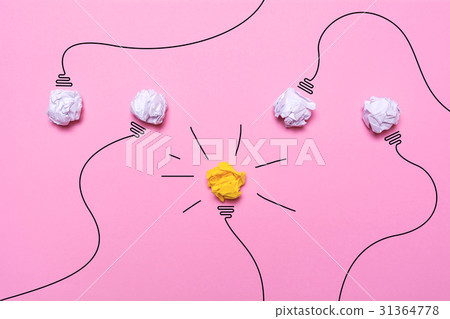 Creative idea of crumpled paper. A burning light bulb on a pink background. Education concept. 31364778