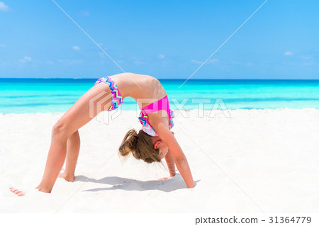 Active little girl at beach having a lot of fun 31364779