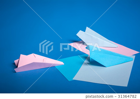 Place for making origami paper planes. Blue, blue, pink origami airplanes crafts. Place for making origami paper planes. Blue, blue, pink origami airplanes crafts. 31364782
