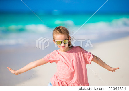 Portrait of adorable little girl at beach during 31364824