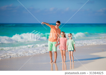 Family walking on white tropical beach on Family walking on white tropical beach on 31364825
