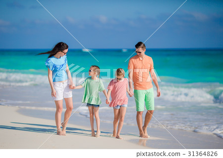 Family of four on a tropical beach Family of four on a tropical beach 31364826