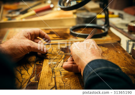 Senior wood carving professional during work 31365190
