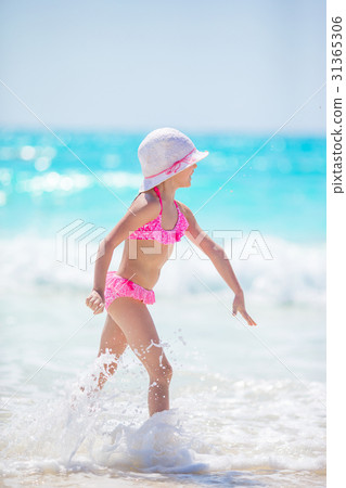 Adorable little girl at beach having a lot of fun Adorable little girl at beach having a lot of fun 31365306