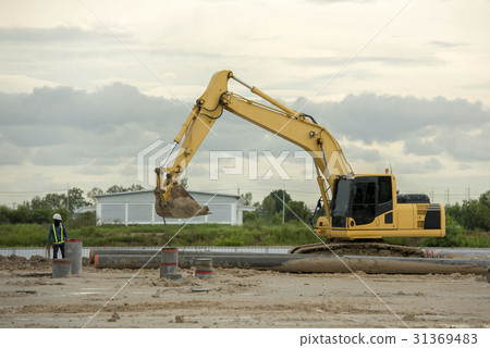 Excavator on a construction site. Yellow excavator 31369483