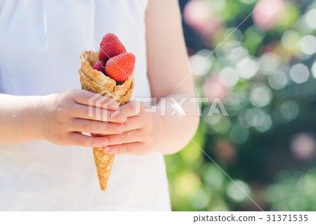 Waffle cone filled with strawberries Waffle cone filled with strawberries 31371535
