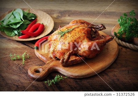 Whole roasted chicken on cutting board. Vintage 31372526