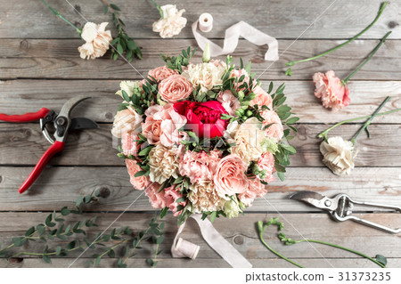 flowers and garden tools. The florist work table flowers and garden tools. The florist work table 31373235