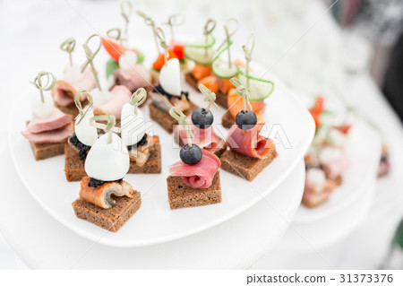 the buffet at the reception. Assortment of canapes 31373376