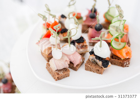 the buffet at the reception. Assortment of canapes the buffet at the reception. Assortment of canapes 31373377