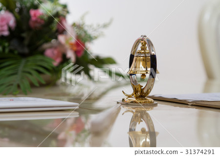 Bell decoration on the glossy table 31374291