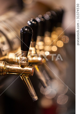 A lot of Golden beer taps at the bar 31374530