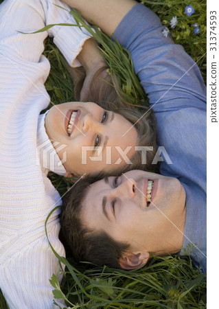 Young pair in the grass  31374593