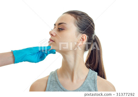 cosmetologist in glove touches the face of the cosmetologist in glove touches the face of the 31377292