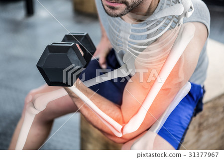 Highlighted arm of strong man lifting weights Highlighted arm of strong man lifting weights 31377967