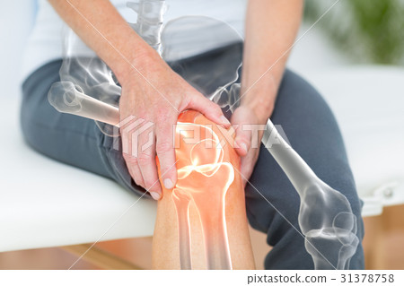 Mid section of man suffering with knee pain Mid section of man suffering with knee pain 31378758