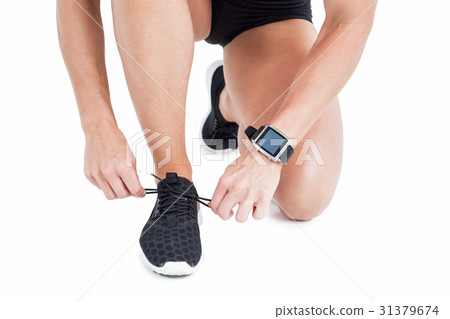 Female athlete tying her shoelace 31379674