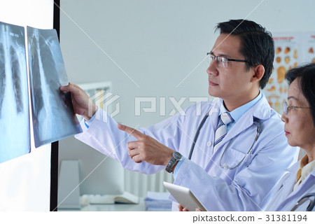 Vietnamese Physicians Examining X-Ray Vietnamese Physicians Examining X-Ray 31381194