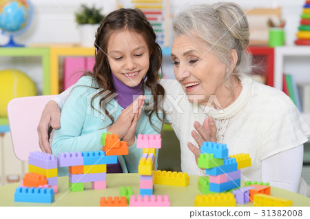 Grandmother playing with granddaughter Grandmother playing with granddaughter 31382008