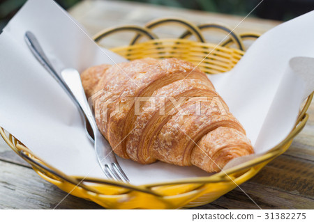 fresh croissant on plastic basket 31382275