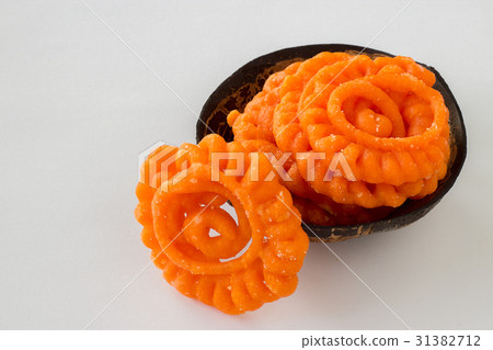 Indian sweet jalebi in coconut shell cup 31382712
