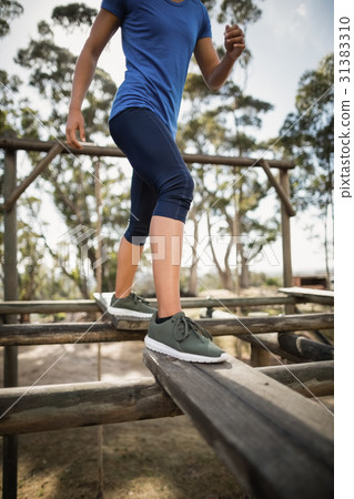 Fit woman practicing during obstacle course 31383310