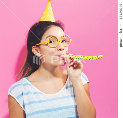 Young woman with noisemaker 31389015
