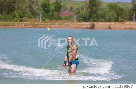 Man study wakeboarding on a blue lake Man study wakeboarding on a blue lake 31389807