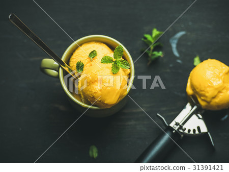 Mango sorbet ice cream scoops with mint, top view 31391421
